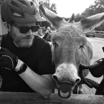 Philip Newborough and a donkey enjoying a beer.